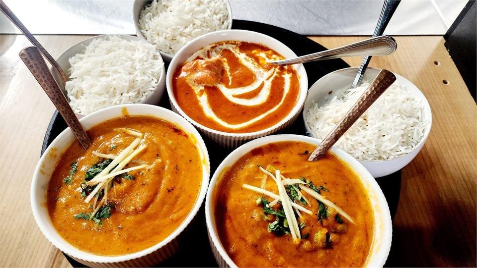 A spread of curries including butter chicken